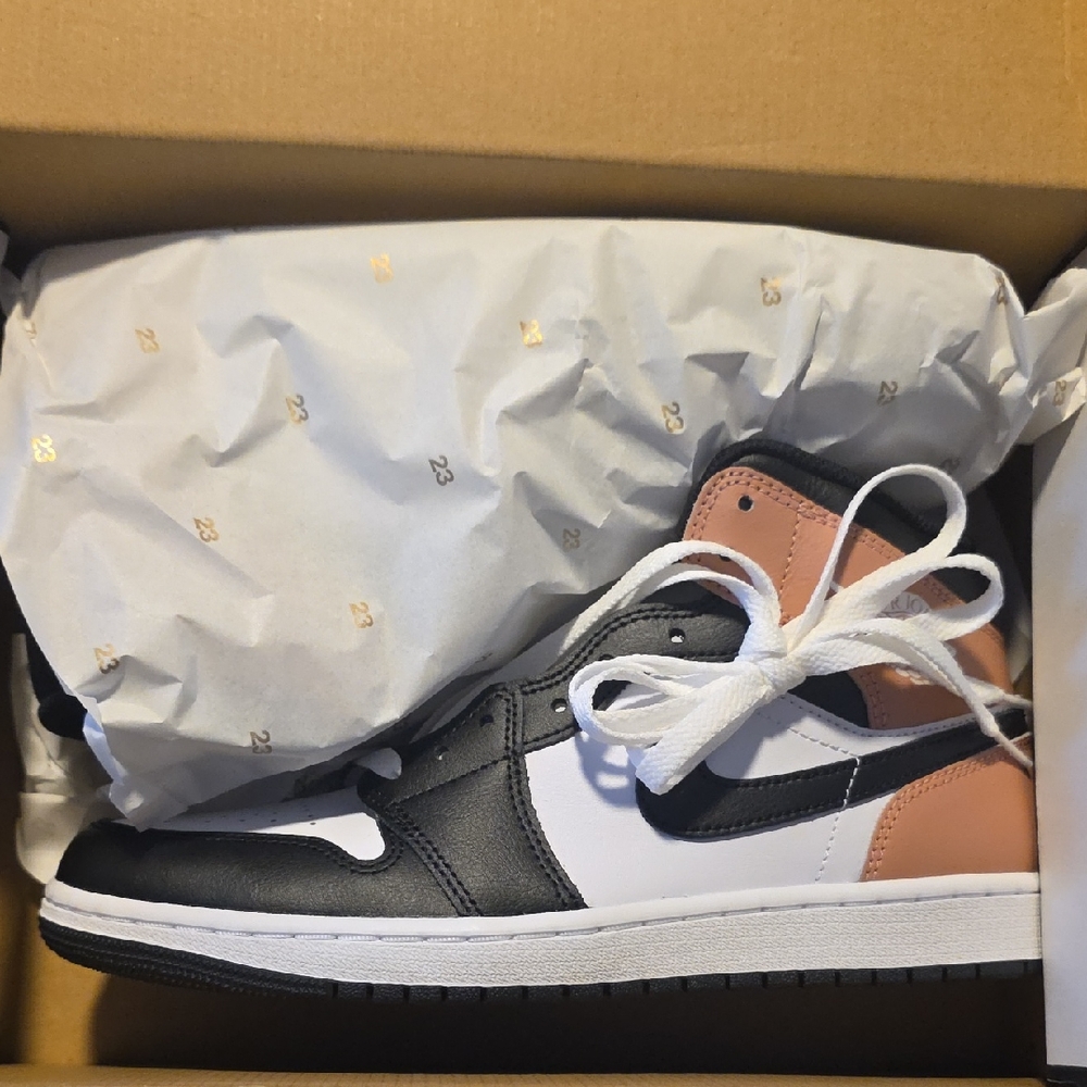 Nike Air Jordan 1 Mid in the "White Black Rust Pink" colorway.